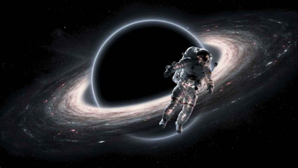 Ilustração científica realista mostra astronauta sendo distorcido pelo efeito de espaguetificação ao se aproximar de um buraco negro supermassivo. Entenda o que aconteceria com o corpo humano