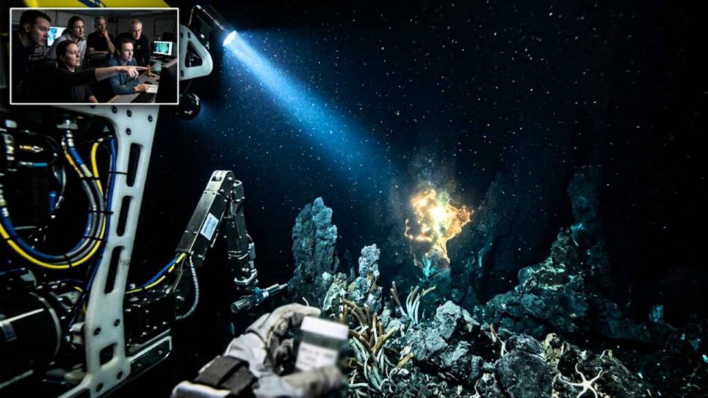 Submarino robótico explorando as profundezas do oceano, apontando uma forte lanterna em direção a um brilho dourado misterioso que surge entre formações rochosas no fundo do mar.